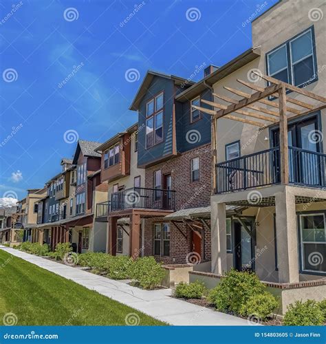 Square Frame Row Of Homes With Porches And Small Balconies Under Blue