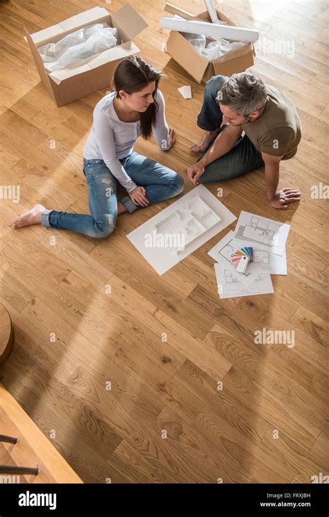 Couple Heureux Dans Les Tenues De Assis Pieds Nus Sur Le Parquet De