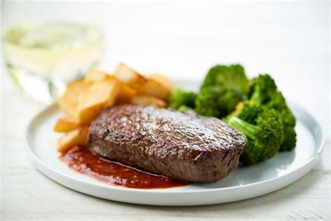 A Plate With Steak Potatoes And Broccoli On It