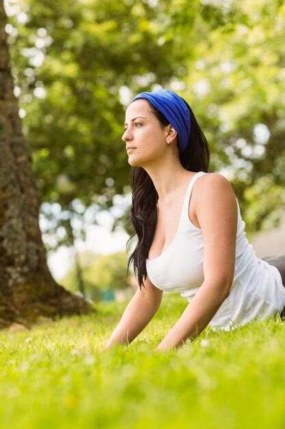 Premium Photo Peaceful Brunette Doing Yoga On Grass