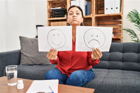 Middle Age Hispanic Woman Working On Depression Holding Sad To Happy