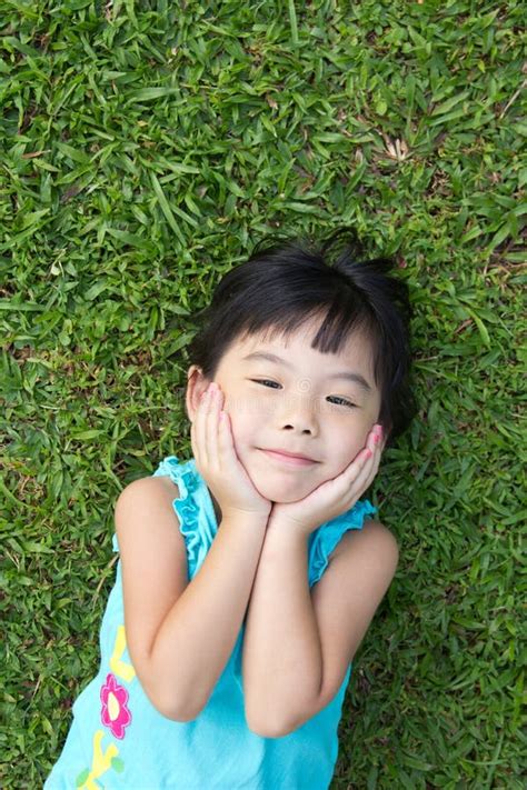 Kid lying on grass stock image. Image of green, grass - 13623715