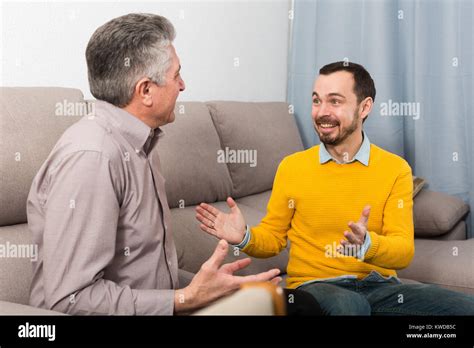 Mature Father And His Son Is Warm And Friendly Conversation At Home Stock Photo Alamy