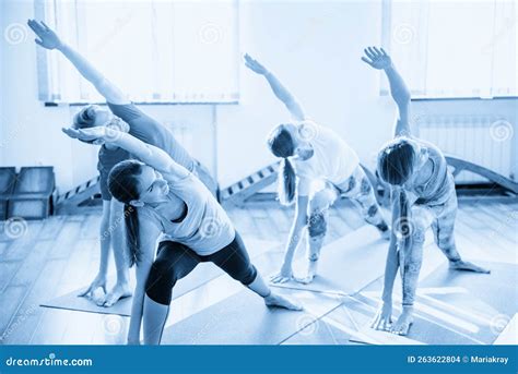 Yoga Class Group Of People Relaxing And Doing Yoga Pose Wellness And