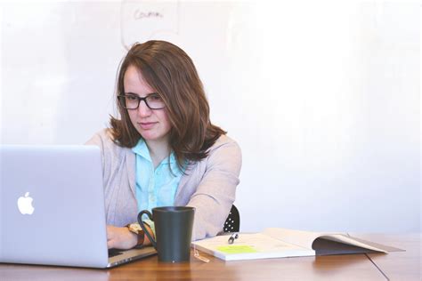 Man With Headphones Facing Computer Monitor · Free Stock Photo
