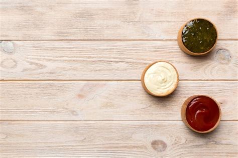 Premium Photo Different Types Of Sauces In Bowls On A Colored Board