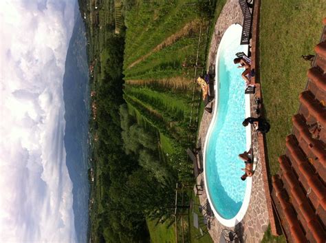 an aerial view of a swimming pool in the middle of a grassy area with ...