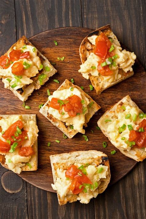 Toasted Bread With Scrambled Eggs Tomato And Green Onion Stock Photo