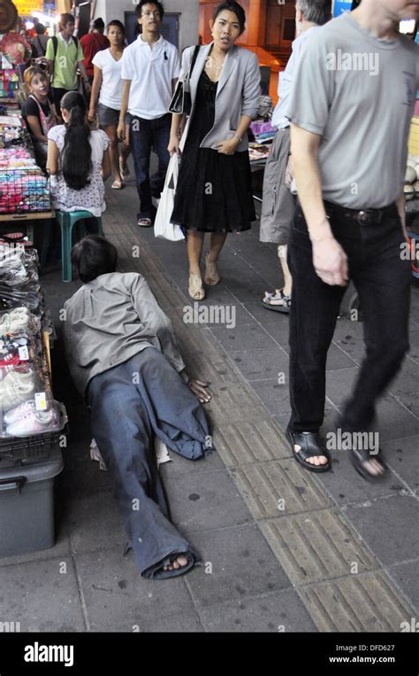 Bangkok Thailand Beggar Laying On The Sidewalk In The Nana Area