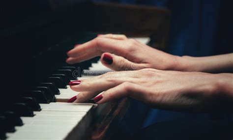 Hands Of A Beautiful Young Woman Playing The Piano Side View