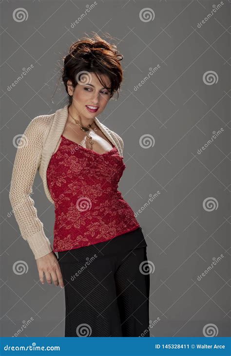 Gorgeous Brunette Model Poses In A Studio Environment Against A Dark Background Stock Image