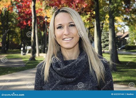 Portrait Of A Mature Woman Smiling At The Camera Stock Photo Image Of Green Camera 63233144