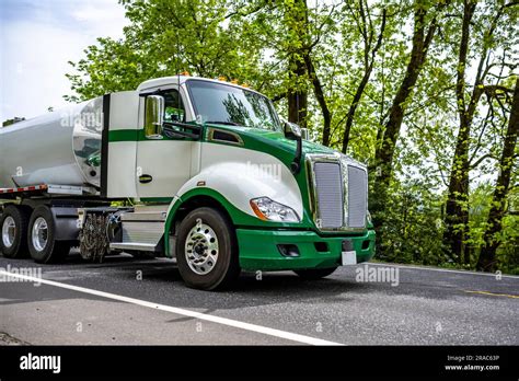 Industrial Standard Green And White Big Rig Day Cab Semi Truck Tractor Transporting Liquid Cargo