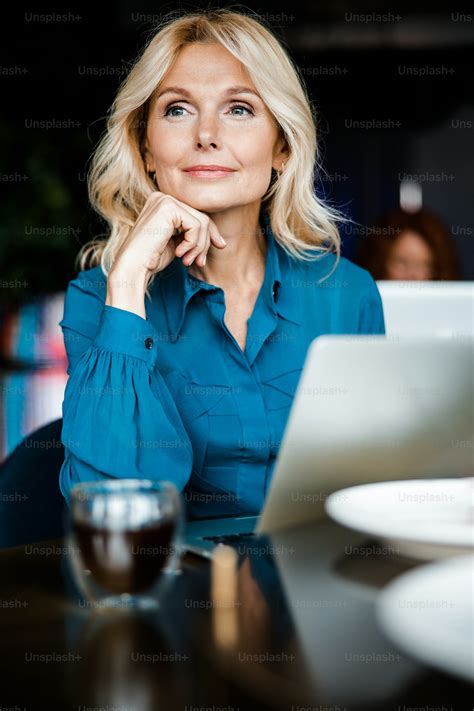 Charming elegant woman using modern laptop in cafe stock photo photo