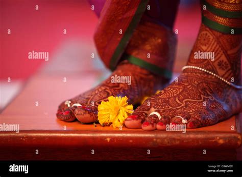 A Ritual During A Traditional Indian Marriage With A Marigold Flower Kept Near The Brides Feet