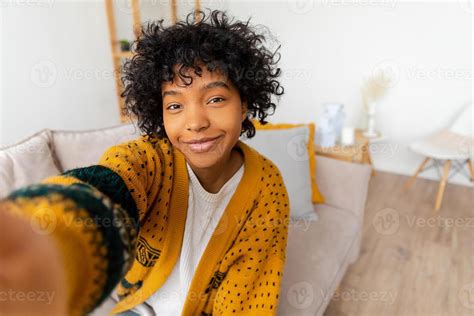 Happy african american teen girl blogger smiling face talking to webcam ...