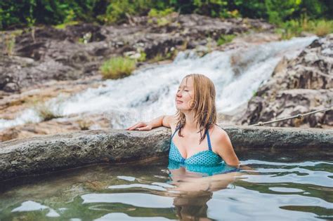 Geothermal Spa Woman Relaxing In Hot Spring Pool Against The Background Of A Waterfall Stock
