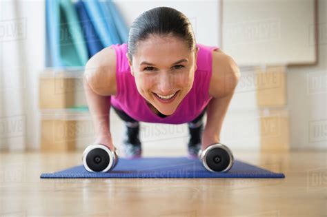 Caucasian Woman Doing Push Ups On Yoga Mat Stock Photo Dissolve