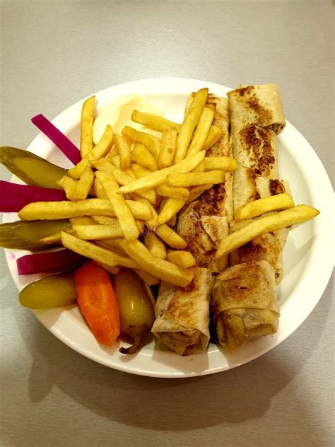 Arabic Chicken Shawarma Dish With French Fries And Pickles Stock Photo