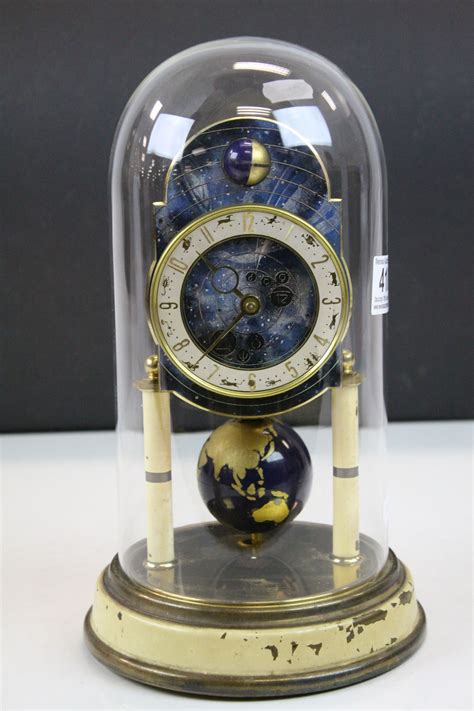 Glass Dome Covered Anniversary Type Clock With Zodiac Dial And World Globe Pendulum By Kaiser Stan