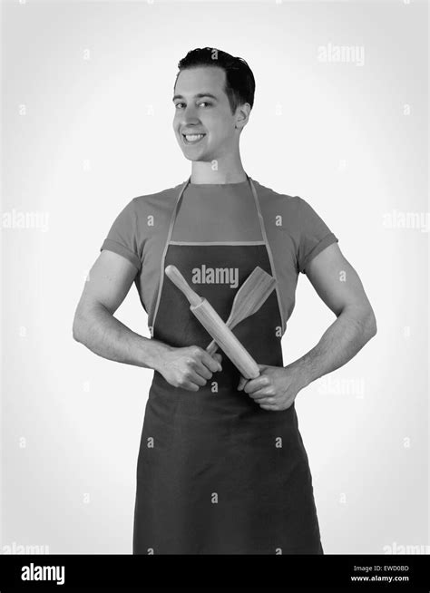 The Man In The Kitchen Wearing An Apron Holding A Rolling Pin Isolated