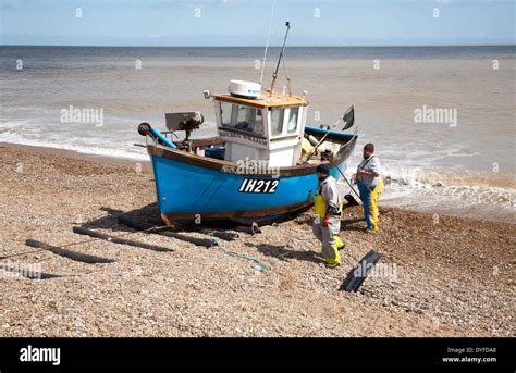 Small Inshore Fishing Boat Landing On The Beach After Six Hours At Sea