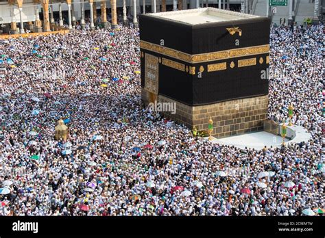 The Holy Kaaba. Crowd of people walking around Kaaba. Tawaf part during ...