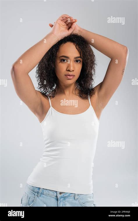 Brunette African American Woman In White Tank Top Posing With Hands