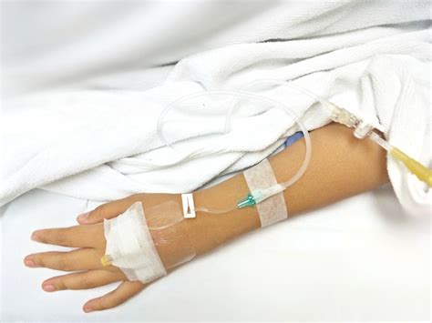 Premium Photo Cropped Hand Of Patient With Iv Drip On Bed At Hospital