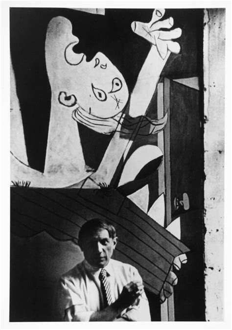 Picasso in front of his painting Guernica