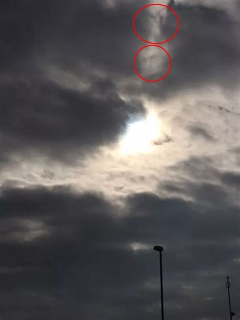 Solar Eclipse Woman Captures Mystery Face In Cloud After Taking