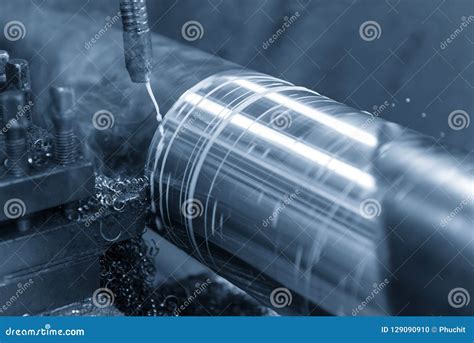 The Operation Of Lathe Machine Cutting The Steel Shaft Stock Photo