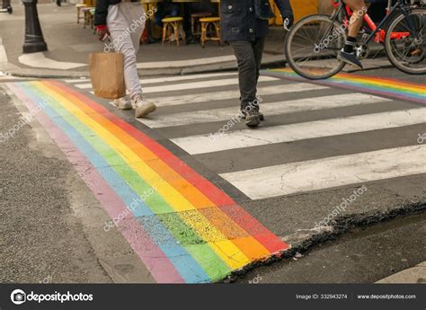 Gay Pride Flag Rainbow Flag Of The LGBT Community On Crosswalk With People Crossing In Paris