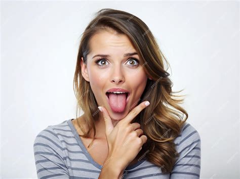 Premium Photo A Young Women Making A Funny Face With Her Tongue Out And Hand On Her Chin