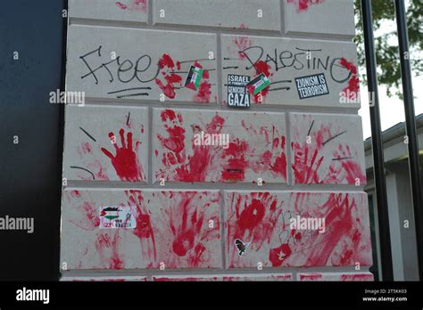 Red-paint handprints, protest stickers and graffiti remain on a wall ...