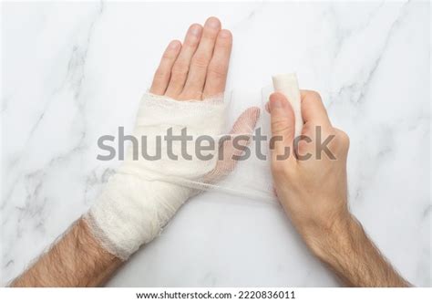 Man Bandages His Own Injured Hand Stock Photo 2220836011 | Shutterstock