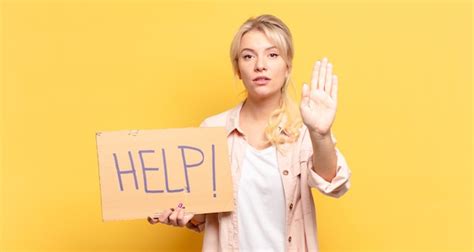 Premium Photo Blonde Woman Looking Serious Stern Displeased And Angry Showing Open Palm