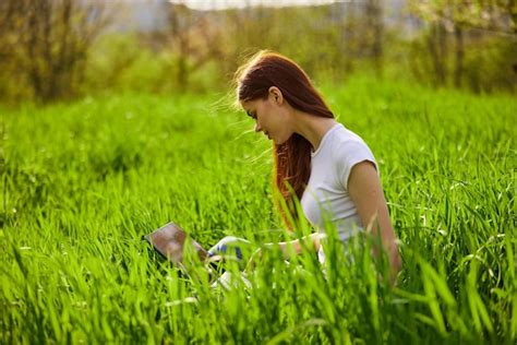 Premium Photo Rear View Of Young Woman Picking Flowers On Field