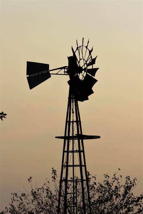 Windmill Silhouette at Sunset with a Blazing Red Sky Out in the Country ...