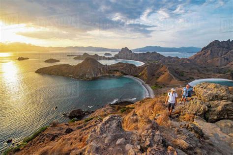 Couple hiking up trail, Padar Island (Pulau Padar) within Komodo ...