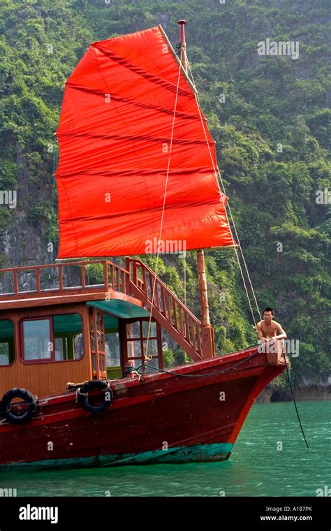 Local Man On A Traditional Vietnamese Sailing Junk Halong Bay Vietnam