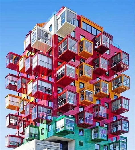 A Multi Colored Building With Balconies On The Top And Bottom Floors