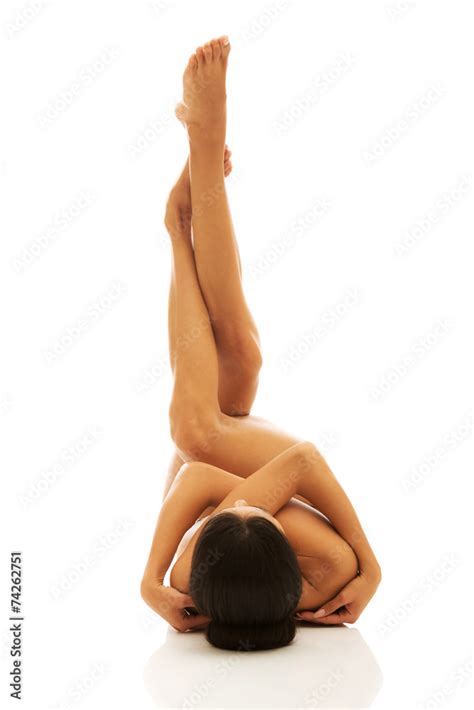 Nude Woman Lying Legs Up High Embracing Herself Stock Photo Adobe Stock