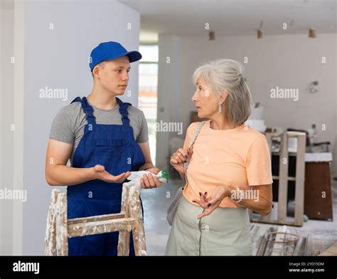 Mature Woman Discusses Working Moments With A Fifteen Year Old Worker Stock Photo Alamy