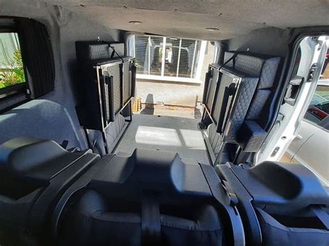 The Inside Of A Vehicle With Seats And Windows