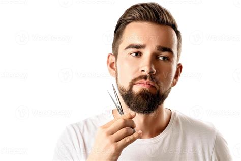 Handsome man trimming his beard with a scissors 16293638 Stock Photo at ...