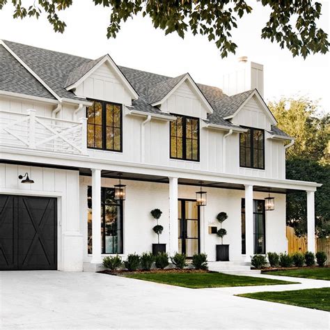 White Colonial House With Black Garage Doors - ZTech