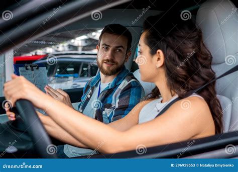 Young Ladu Studying In Driving School While Looking At Male Instructor