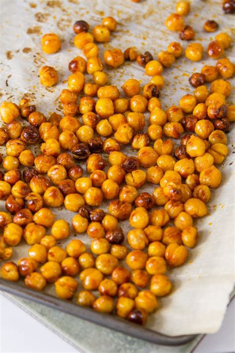 Buffalo Roasted Chickpeas On Parchment Paper In A Rimmed Baking Sheet