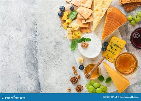 Assortment Of Cheese Honey Cracker Blueberries Grapes With Red And